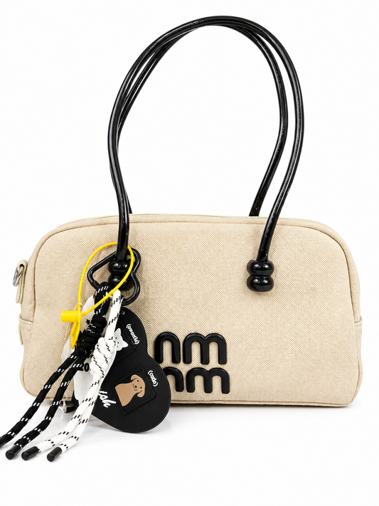 A premium Elegant Canvas Mini Handbag with Glossy Handles & Charm Accessories β Beige