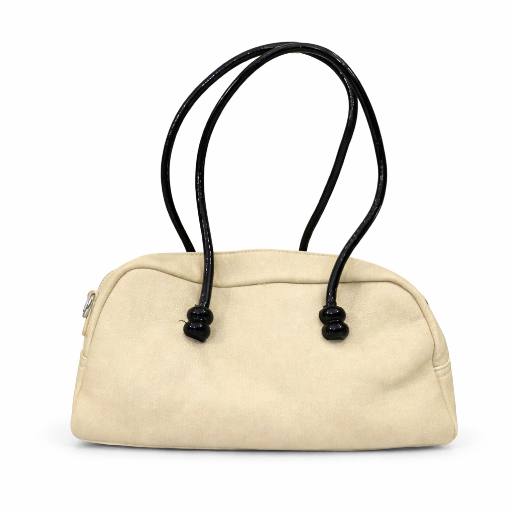 A premium Elegant Canvas Mini Handbag with Glossy Handles & Charm Accessories – Beige